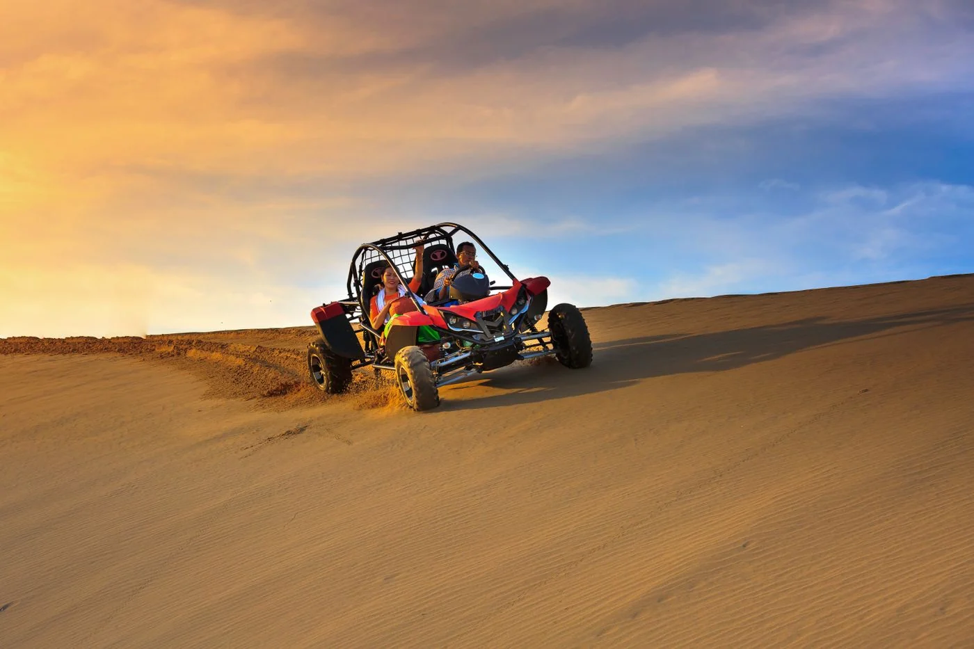 Dune buggy at sunset · illustrative photograph