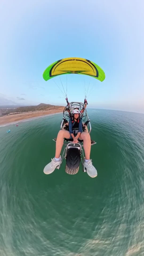 Tandem paramotor over the coast · actual flying partner
