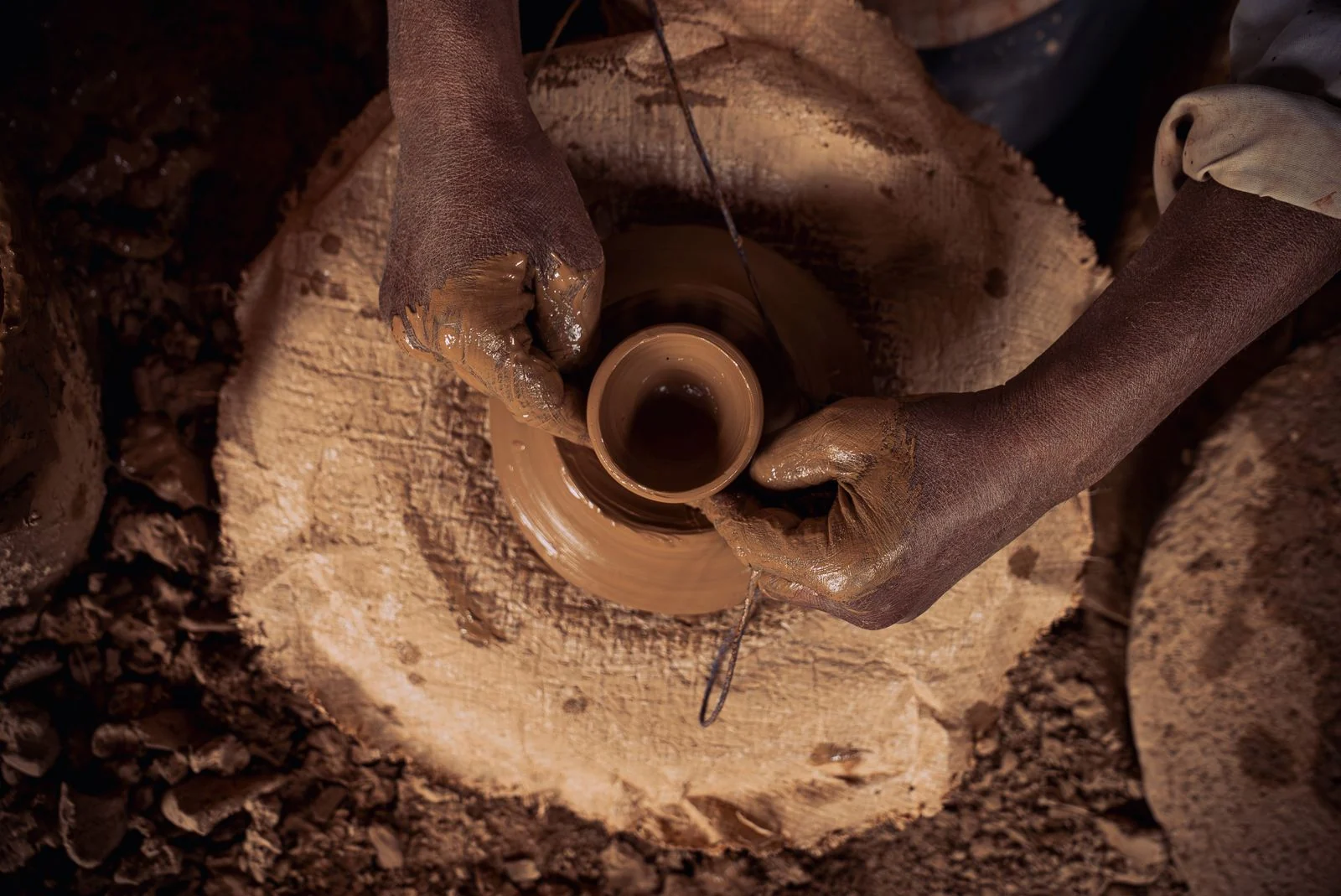Hands shaping clay · illustrative workshop photograph