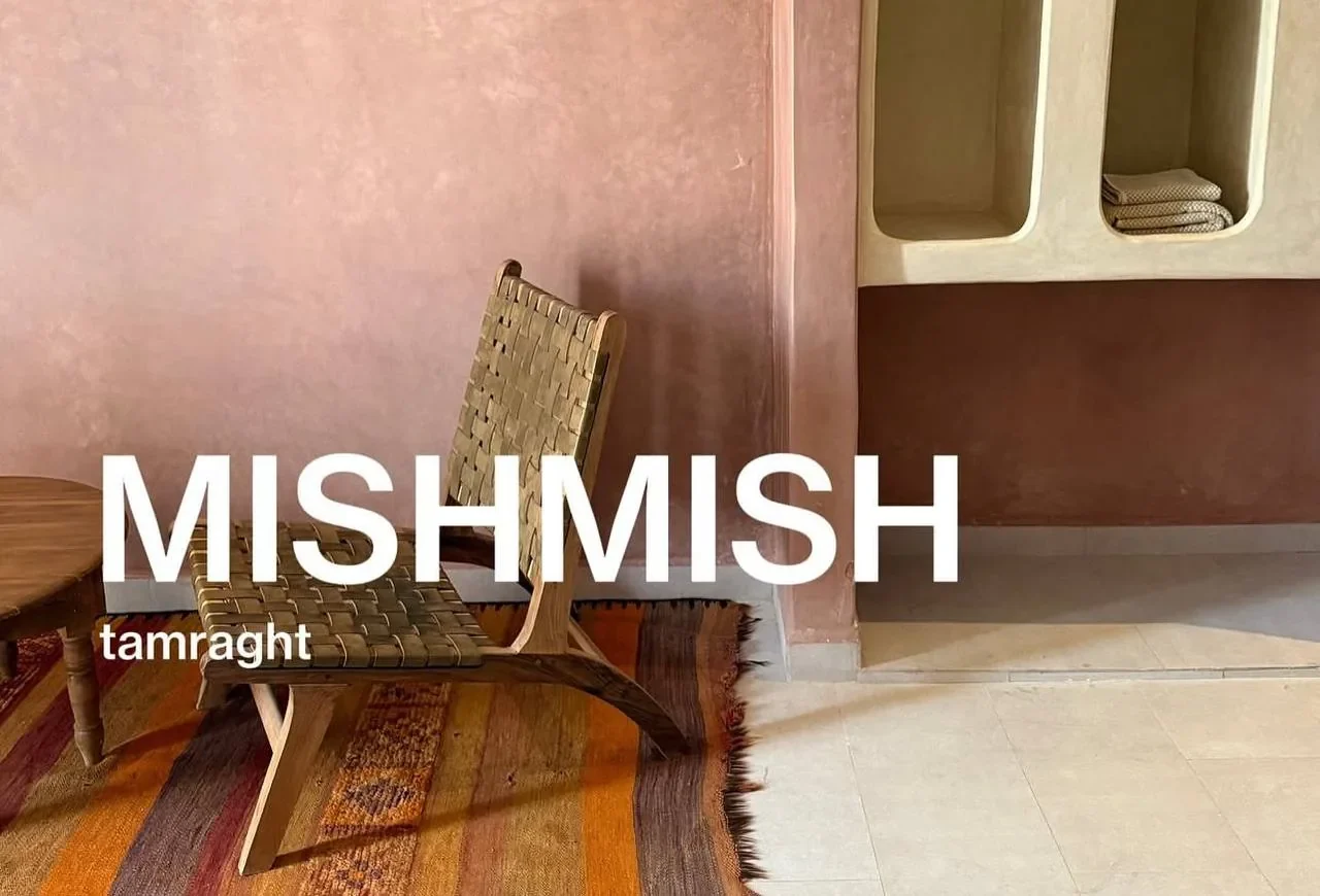 Mishmish Tamraght interior with woven chair and warm terracotta walls